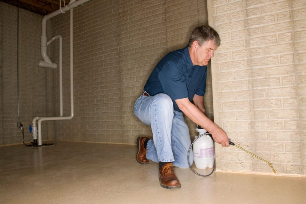 Worker using pesticides  inside a building
